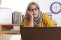 Tired Sleepy Muslim Businesswoman Waiting in Front of Her laptop Royalty Free Stock Photo