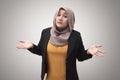 Portrait of Asian muslim businesswoman wearing hijab shows refusal or denial gesture, shoulder shrug Royalty Free Stock Photo