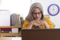 Muslim Businesswoman Working on Laptop at the Office, Thinking Gesture Royalty Free Stock Photo