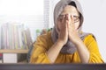 Muslim Businesswoman Working on Laptop at the Office, Tired Stress Headache Gesture Royalty Free Stock Photo