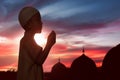 Portrait of asian muslim child raising hand and praying