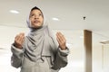 Portrait of asian muslim child wearing hijab dress praying