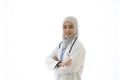 Portrait of Asian muslim female doctor smiling and looking to camera on white background Royalty Free Stock Photo