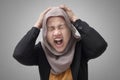 Portrait of Asian muslim lady wearing hijab shows angry screaming gesture, stress depressed business woman Royalty Free Stock Photo