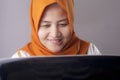 Woman With Naughty Expression Looking at Laptop