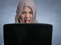 Muslim Woman Watching Disgusted Movie on Laptop