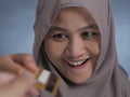 Muslim Woman Smiling When Receiving Credit Card Royalty Free Stock Photo