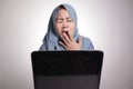 Muslim Woman Working on Laptop, Tired Sleepy Expression, Exhausted Overworked Concept Royalty Free Stock Photo
