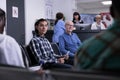 Portrait of asian patient in hospital reception lobby, sitting in waiting area to attend doctor appointment Royalty Free Stock Photo