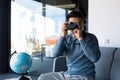 Portrait of an Asian photographer, happy male tourist blogger, working in home office, blogs about travel and teaches photography