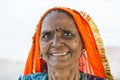 Portrait of Asian senior beautiful woman smiling wearing traditional orange and blue Indian dress sari. Royalty Free Stock Photo
