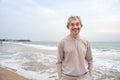 portrait asian senior male smiling and standing in nature,happy mature man enjoy summer time on the beach Royalty Free Stock Photo