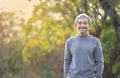 portrait asian senior man with grey hair and beard relaxing in the park Royalty Free Stock Photo