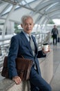 Portrait of Asian senior mature middle aged businessman in modern city Royalty Free Stock Photo