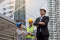 Portrait of a Asian serious engineer wearing safety helmet architects discussing construction plan