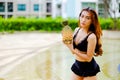 portrait asia sexy woman wearing black swimsuit and sunglasses with pineapple holding in hand at swimming pool , fashion in summer Royalty Free Stock Photo