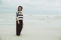 Portrait asian single hipster indy women wear sunglasses lonely stand alone on the beach