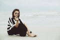 Portrait asian single hipster indy women wear sunglasses siting on the beach