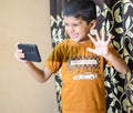 Portrait of Asian smart happy little boy using Mobile phone at home. Little boy holding mobile smart phone, online back to school Royalty Free Stock Photo