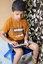 Portrait of Asian smart happy little boy using Mobile phone at home. Little boy holding mobile smart phone, online back to school Royalty Free Stock Photo