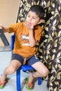 Portrait of Asian smart happy little boy using Mobile phone at home. Little boy holding mobile smart phone, online back to school Royalty Free Stock Photo