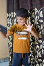 Portrait of Asian smart happy little boy using Mobile phone at home. Little boy holding mobile smart phone, online back to school Royalty Free Stock Photo