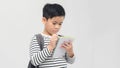 Portrait of asian smiling teen boy with notebook and pen writing something Royalty Free Stock Photo