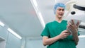 Portrait of Asian surgeon with medical mask standing and holding a tablet in operation theater at a hospital. Team of Professional Royalty Free Stock Photo