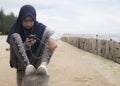 Muslim girl listening to music on phone on the beach Royalty Free Stock Photo