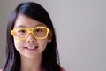 Portrait of Asian teenager with big yellow glasses