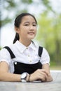 portrait of asian teenager smiling face with green blur background Royalty Free Stock Photo