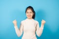 Portrait of Asian teenager wearing light pink sweater excited for success Royalty Free Stock Photo