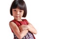 Portrait of an Asian Thai girl, aged 4 to 6 years old, cute face, short hair, wearing a skirt. standing with arms crossed She is a Royalty Free Stock Photo