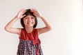 Portrait of an Asian Thai girl, aged 4 to 6 years old, cute face, short hair, wearing a skirt. standing with arms crossed She is a Royalty Free Stock Photo