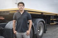 Portrait of Asian a truck driver standing with trailer truck. Royalty Free Stock Photo