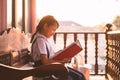 Portrait of asian uniform little child student reading and smiling with happy at home Royalty Free Stock Photo