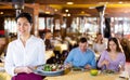 Portrait of asian waitress standing in restaurant Royalty Free Stock Photo