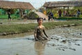 Portrait Asian wet girl enjoys plays in the mud pond and chases group of ducks in the farm