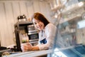 Portrait Asian woman Barista preparing coffee at front counter serving coffee cup to customer Royalty Free Stock Photo