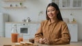 Portrait Asian woman in domestic home kitchen smiling girl prepare meal cook morning breakfast chocolate sandwich and Royalty Free Stock Photo