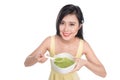 Portrait of asian woman eating/holding a plate of green vegetables soup Royalty Free Stock Photo