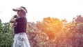 Portrait of a Asian woman golfer in black T-shirt with a golf club on a background of golf courses Royalty Free Stock Photo