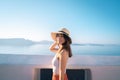 Portrait of an Asian woman looks out over the Aegean Sea by the sea, Santorini, Greece Royalty Free Stock Photo