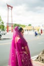 Portrait Asian woman in a margenta Indian tradition sari, she is looking at side while traveling in Thailand