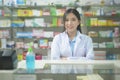 Portrait of asian woman pharmacist wearing lab coat in a modern pharmacy drugstore Royalty Free Stock Photo