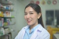 Portrait of asian woman pharmacist wearing lab coat in a modern pharmacy drugstore Royalty Free Stock Photo