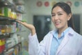 Portrait of asian woman pharmacist wearing lab coat in a modern pharmacy drugstore Royalty Free Stock Photo