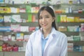 Portrait of asian woman pharmacist wearing lab coat in a modern pharmacy drugstore Royalty Free Stock Photo