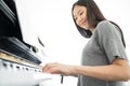 Portrait Asian woman playing playing piano.