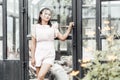 Portrait of asian woman posting and looking camera with glass house